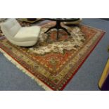 A large cream and red ground rug