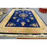 A large Chinese woolen carpet, with a central medallion of flowers and vines with an allover