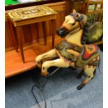 A painted and carved wooden carousel horse, on stand, 99cm in height; together with a Swiss