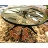 An oak cartwheel dining table with glass top