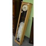 An English Clock Systems Ltd electric wall clock in an oak case