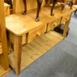 A pine farmhouse dresser base fitted with three drawers