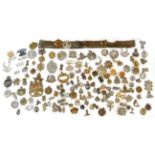 A Large Quantity of British Military Badges, including cap, collar, glengarry and a helmet plate,