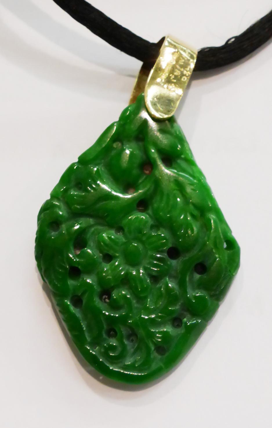 A jadeite pendant, of almost diamond shape and carved with floral and foliate motifs, with a 9ct - Image 2 of 3