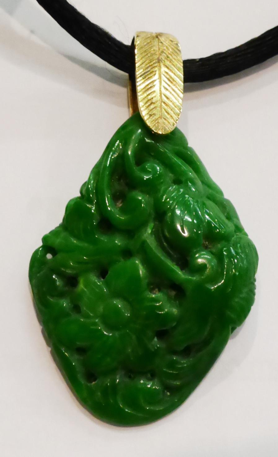 A jadeite pendant, of almost diamond shape and carved with floral and foliate motifs, with a 9ct - Image 3 of 3