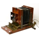 An Unusual Victorian Bellows Camera/Projector with mahogany body on heavy brass frame with crank