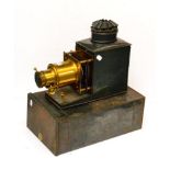 J W Magic Lantern with 7in lens and additional 10 1/2'' lens, engraved 'M W Dunscombe Ltd, Opticians