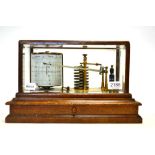 Barograph with eight vacuum sections, brass frame and ink bottle, in oak case with drawer and