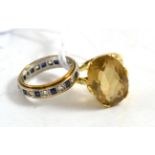 A 9ct gold citrine ring and a 9ct gold sapphire eternity ring (2)