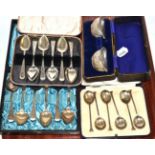 A cased set of silver coffee spoons, two cased sets of silver teaspoons and a cased pair of silver