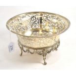 An ornately pierced and footed silver bowl