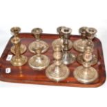 Five pairs of silver dwarf candlesticks