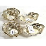 A pair of Victorian small silver baskets and a pair of silver bonbon dishes