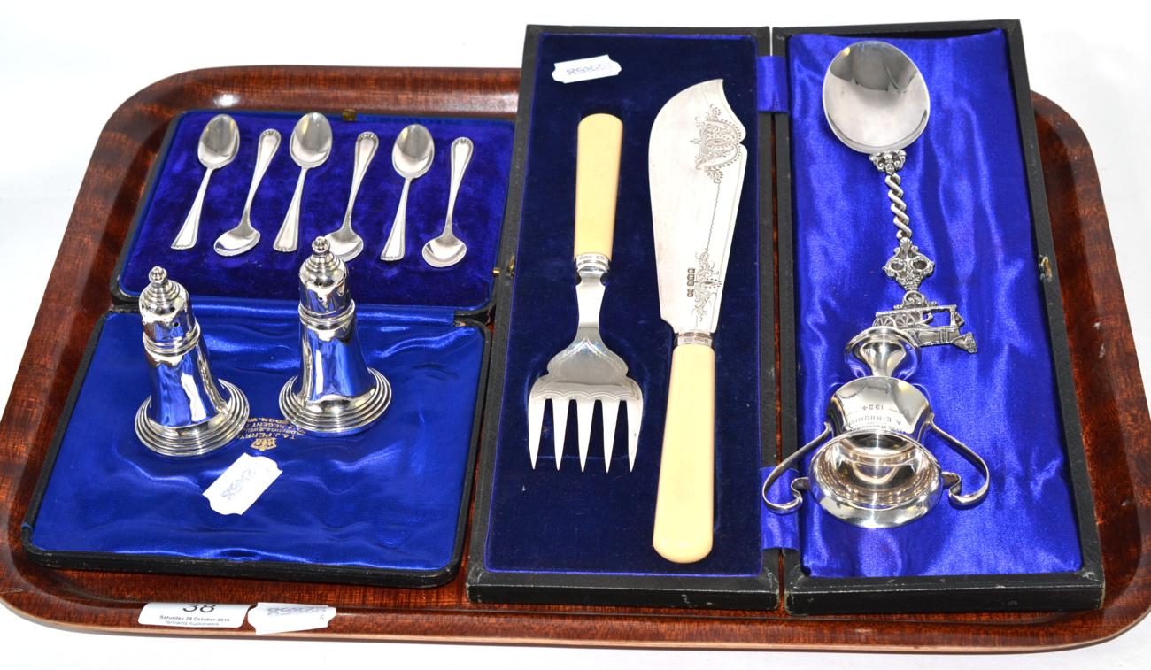 A group of silver including pepperettes, tea spoons, fish servers, trophy etc