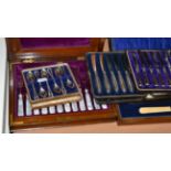 Three cased sets of silver handled butter knives and a quantity of cased plated flatware