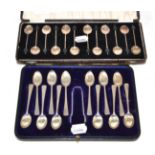 A cased set of twelve silver coffee bean spoons and a cased set of twelve silver teaspoons with