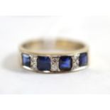 An 18ct white gold sapphire and diamond half hoop ring