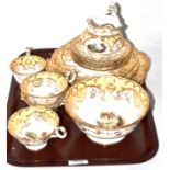 A 19th century English porcelain landscape painted part tea service in the Rockingham style