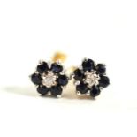 A pair of diamond and sapphire cluster stud earrings