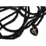 A rose cut diamond and black enamel heart locket pendant, on long jet bead necklace (enamel a.f.)