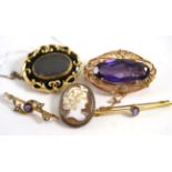 A Victorian mourning brooch, two amethyst bracelets and two other brooches