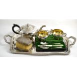 A silver plated three piece tea service, a twin handled tray, two brushes and a Christening set