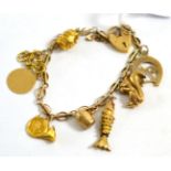 A 9ct gold charm bracelet with 9ct and other charms