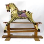 A Dapple Grey Painted Rocking Horse, on treadle stand, with saddle and bridle, real mane and tail,