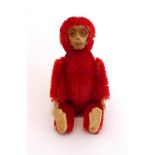 Miniature Schuco Red Monkey Powder Compact, with removable head, hinged body enclosing pale pink