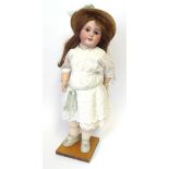 A French Jumeau Bisque Socket Head Child Doll, impressed '10' and stamped in blue 'Tete Jumeau',