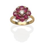 An 18 Carat Gold Ruby and Diamond Cluster Ring, a round brilliant cut diamond between pear cut and