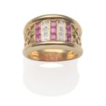 A Ruby and Diamond Ring, with three columns of calibré cut rubies in yellow channel settings, spaced