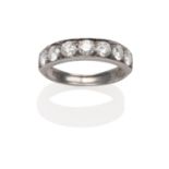 A Diamond Half Hoop Ring, seven round brilliant cut diamonds in a white carved setting on a plain