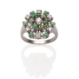 A Diamond and Turquoise Cluster Ring, a central round brilliant cut diamond, within a border of