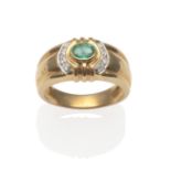 An Emerald and Diamond Ring, an oval cut emerald in a yellow rubbed over setting flanked by