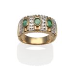 An Emerald and Diamond Ring, three oval cut emeralds in yellow rubbed over settings, spaced by