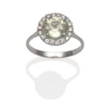 A Pale Yellow Sapphire and Diamond Cluster Ring, a round cut sapphire within a border of round