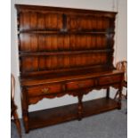 A Titchmarsh & Goodwin Oak Dresser, in George III style, the rack with two shelves and a small