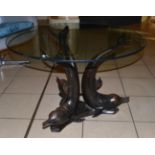 A Circular Glass Top Coffee Table, the metal base in the form of dolphin, diameter 76cm