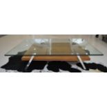 A Modern Rectangular Glass Top Coffee Table, raised on four chrome legs joined by a walnut undertier