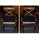 A Pair of Regency Style Beech, Ebonised and Parcel Gilt High Chairs, with black squab cushions,