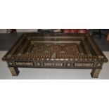 A Moroccan Style Coffee Table, of massive proportions, decorated overall with geometic patterns,