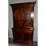 A Reproduction Hardwood Victorian Style Bookcase, the bold pediment above arched glazed doors