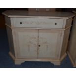 An Italian Style Cream Painted Sideboard, of recent date, of canted form with a single frieze drawer