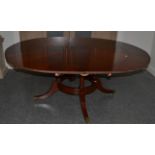 A Reproduction Mahogany Jupe Style Dining Table, inlaid with an oak and ebony sun burst emblem