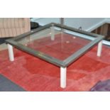 A Pewter Effect Glass Top Square Form Coffee Table, of recent date, raised on white painted square