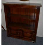 A Titchmarsh & Goodwin Oak Dwarf Bookcase, with two shelves above two fielded cupboard doors, raised