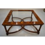 A Walnut and Oyster Veneered Coffee Table, of recent date, the moulded frame with plate glass top