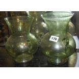 Pair of Islamic pale green glass hanging Mosque lamps of globular form with large flaring rim and