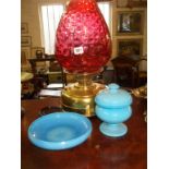 Oil lamp with cranberry glass shade on brass base (converted), an opaque blue-glass lidded pot and a